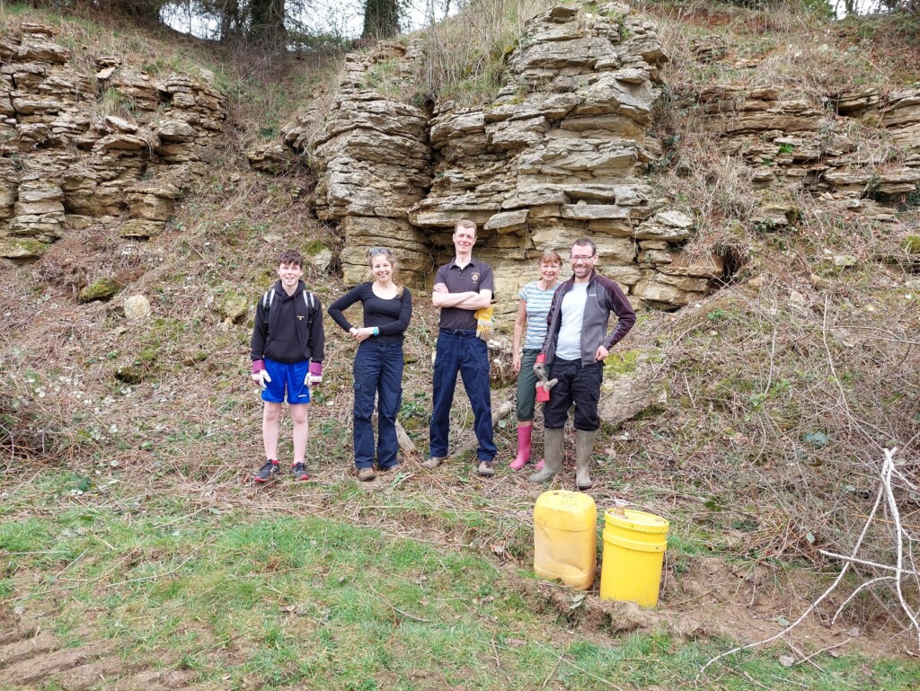 A group of people standing in front of a tree that has been cut

Description automatically generated with low confidence