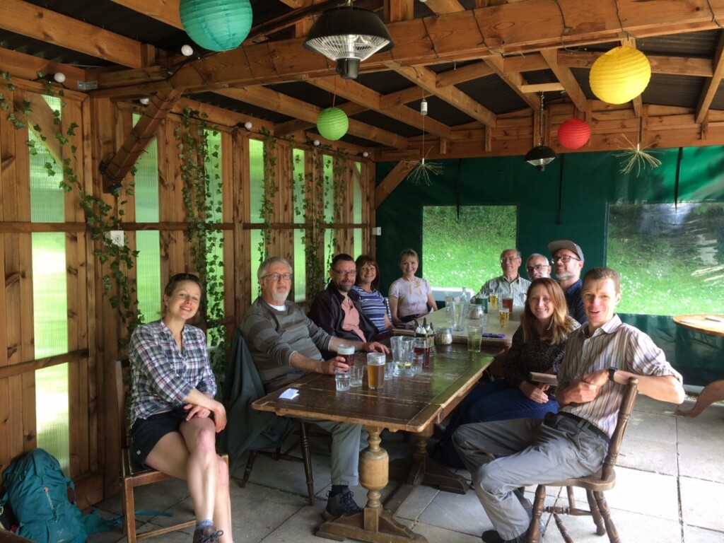 A group of people sitting around a table

Description automatically generated